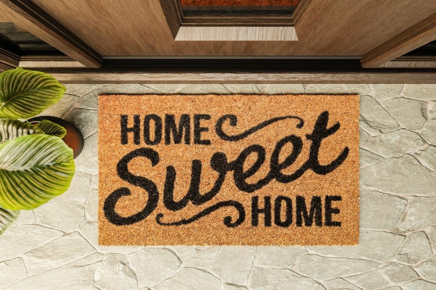A door mat reading home sweet home in cursive font.