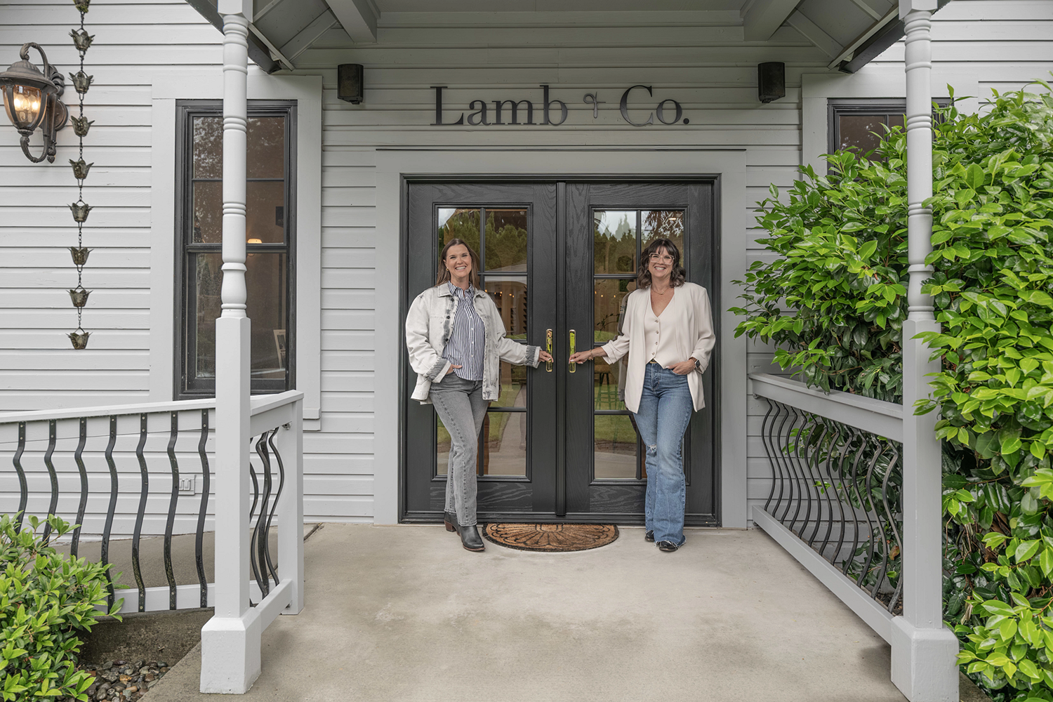 Lyndsay and Leslie Lamb standing in front of the front entry door
