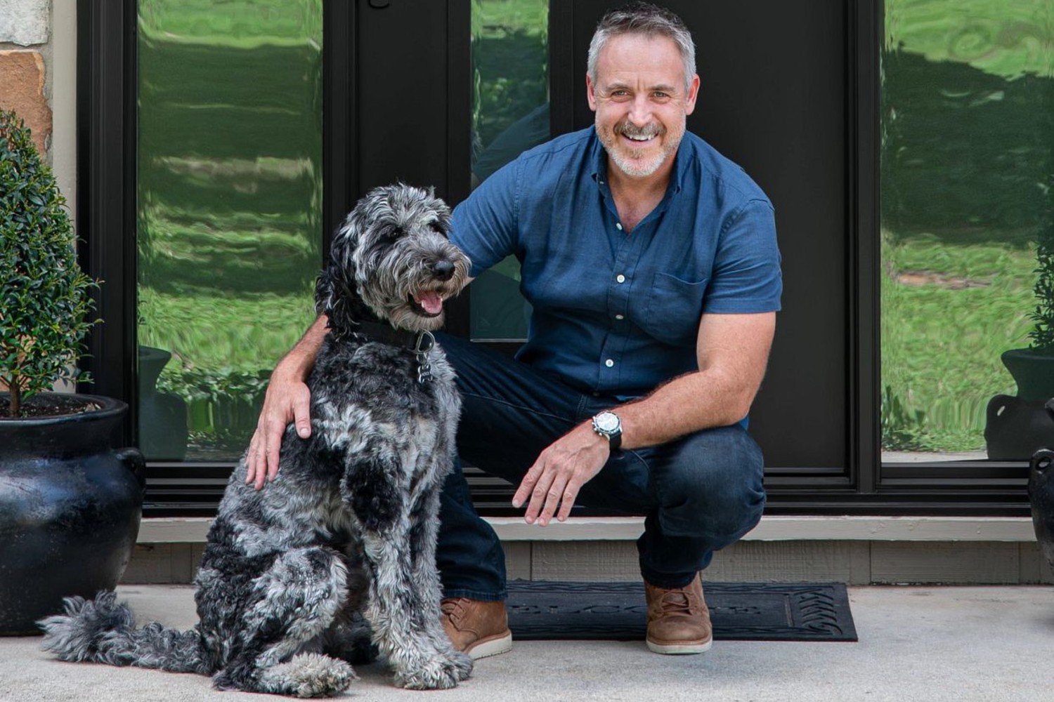 Darren Keef shows off his bacon ensemble door and his dog.
