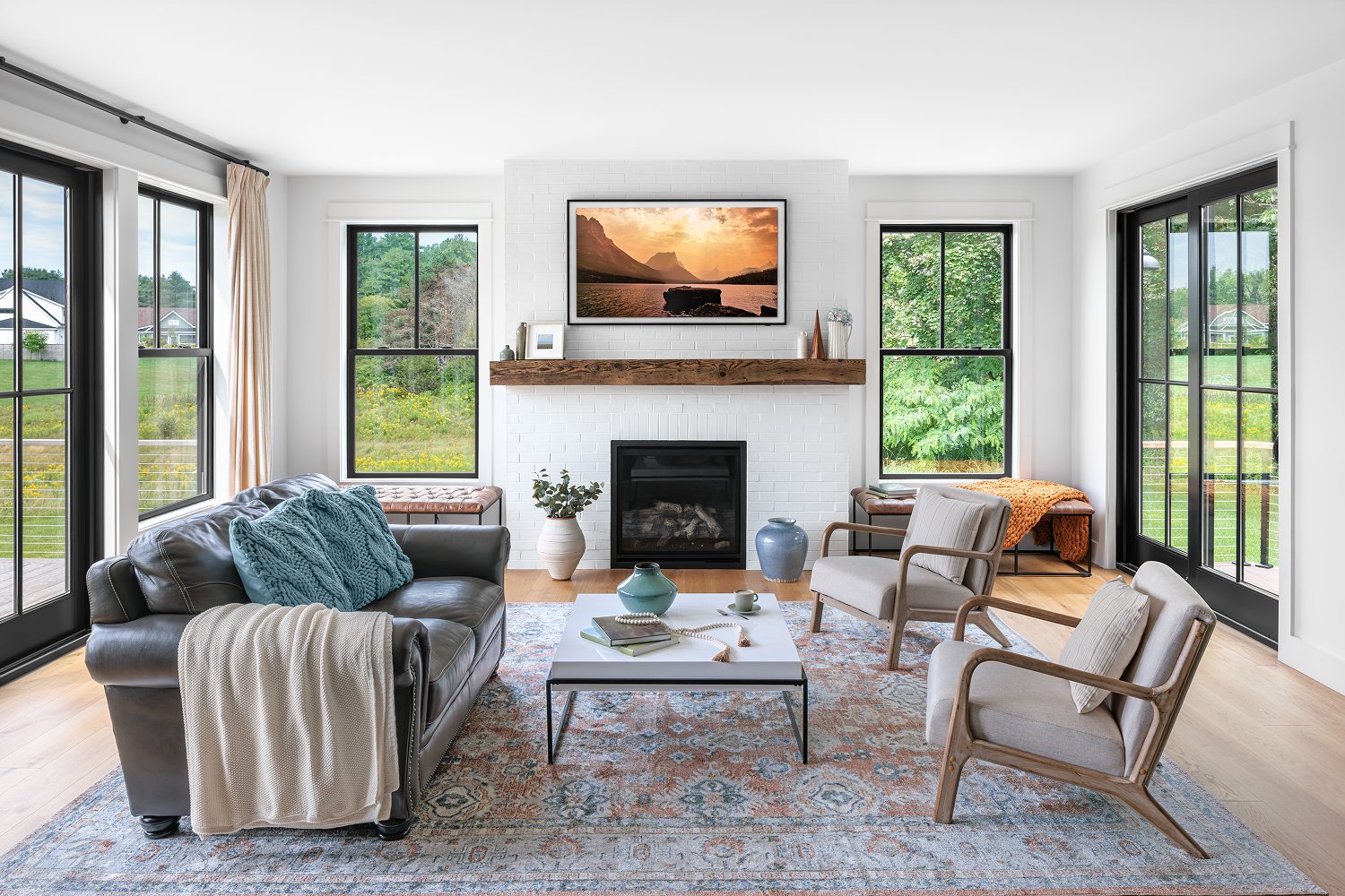 Modern home interior featuring energy-efficient Renewal by Andersen windows and Andersen patio doors with black frames, creating a seamless connection between indoor and outdoor living spaces.