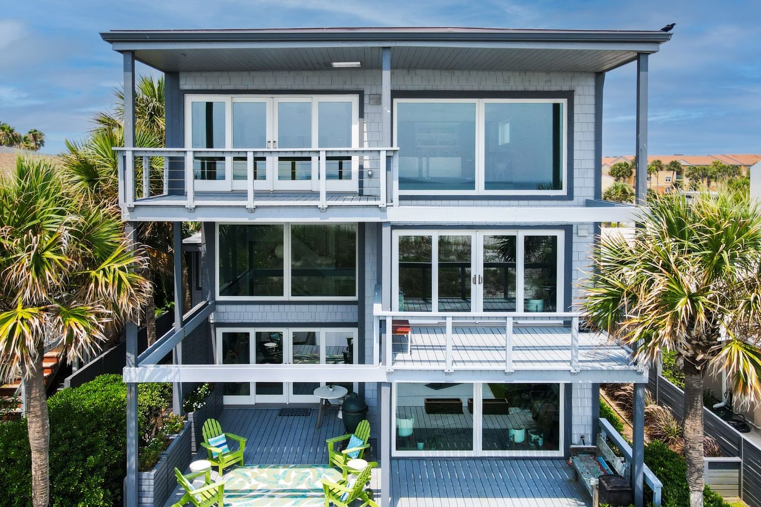 Renewal by Andersen coastal windows and patio doors installed in a waterfront home, combining durable performance with wide, unobstructed glass views.