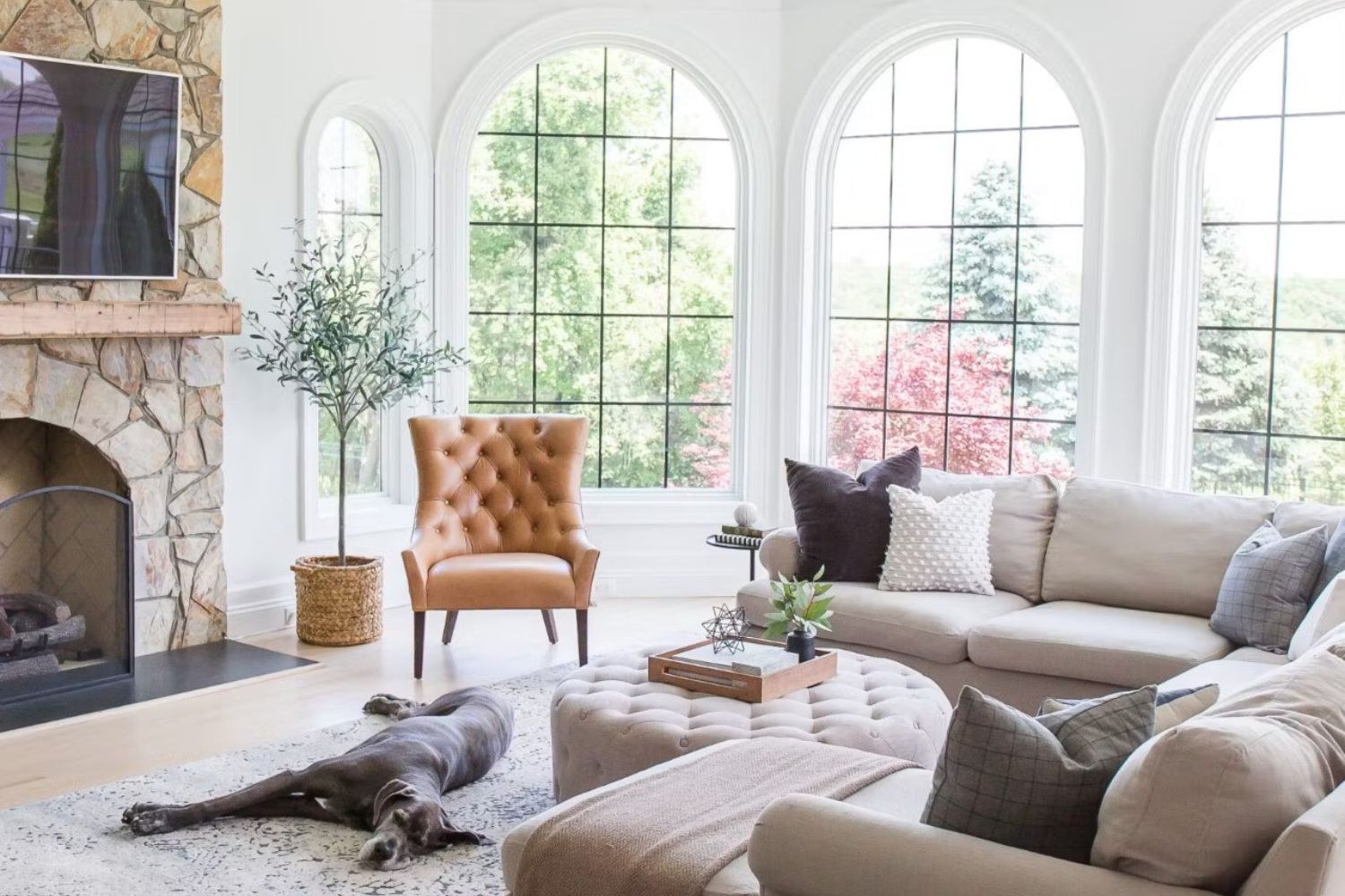 Living room with white walls a large picture windows that let in lots of natural light.