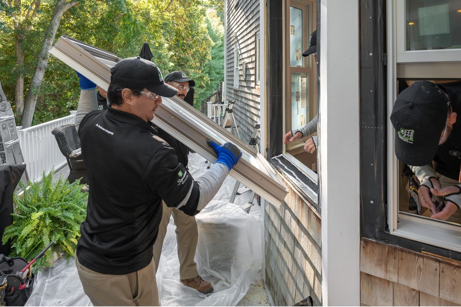 Renewal by Andersen Installer holding a window ready to replace