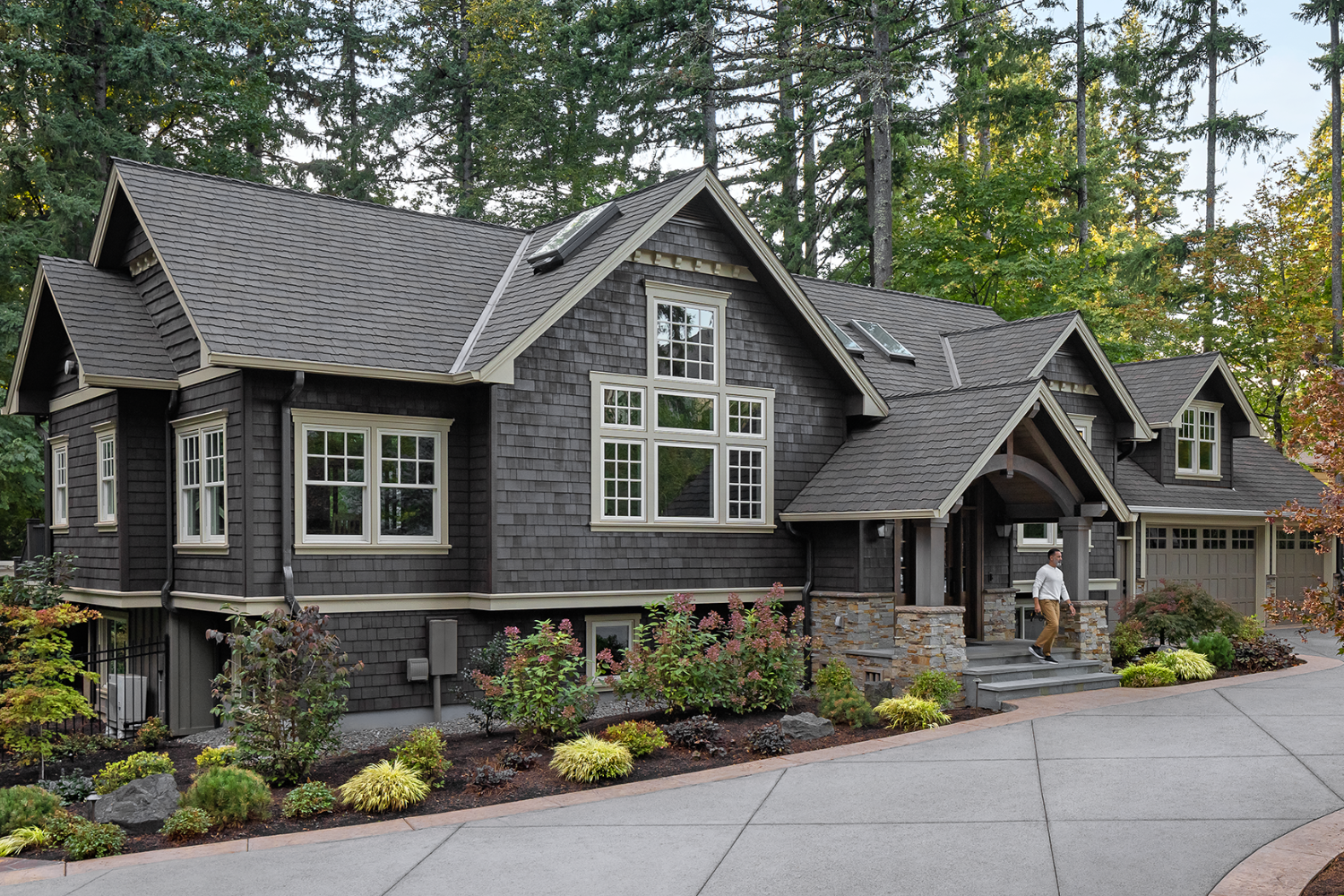 A residential home with a clear driveway and a path leading to the front door.