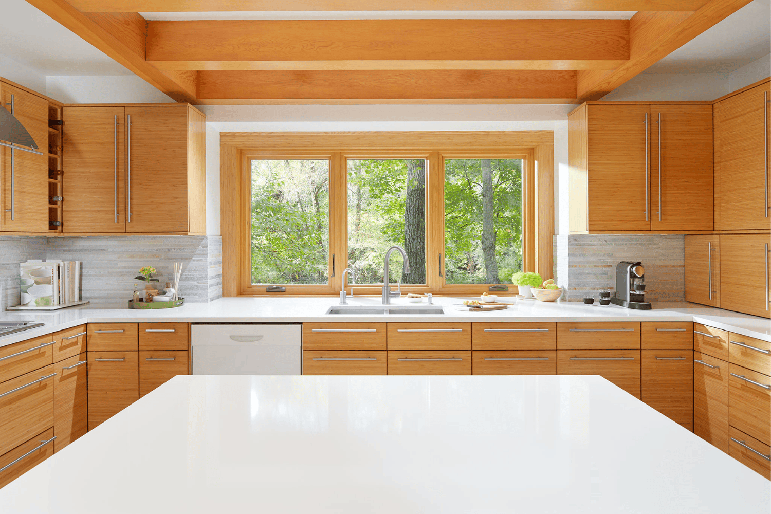 Interior shot of a kitchen island displaying brown casement windows that match the interior of kitchen cupboards