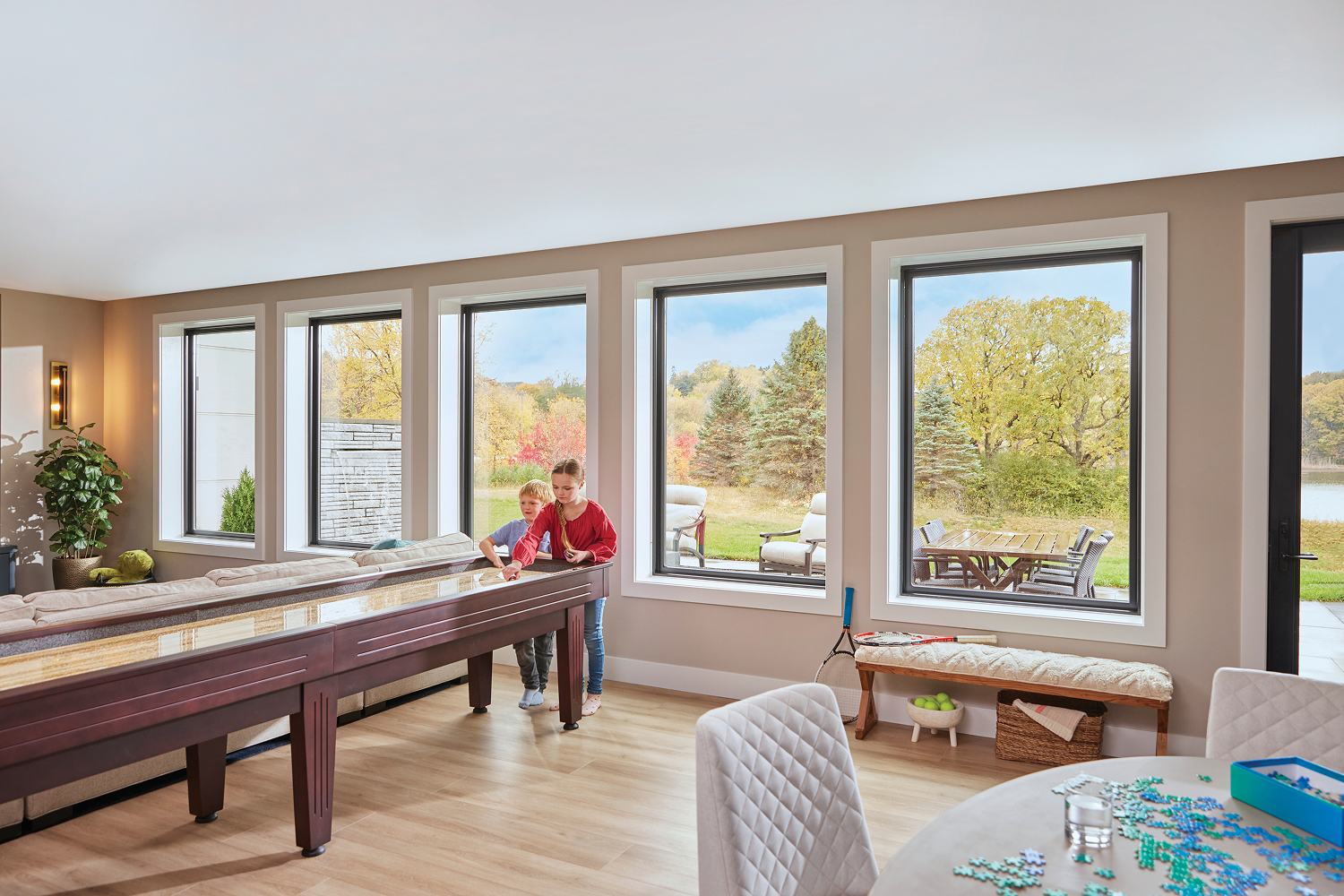 Nicely finished basement game room with large picture windows that look out on the backyard.