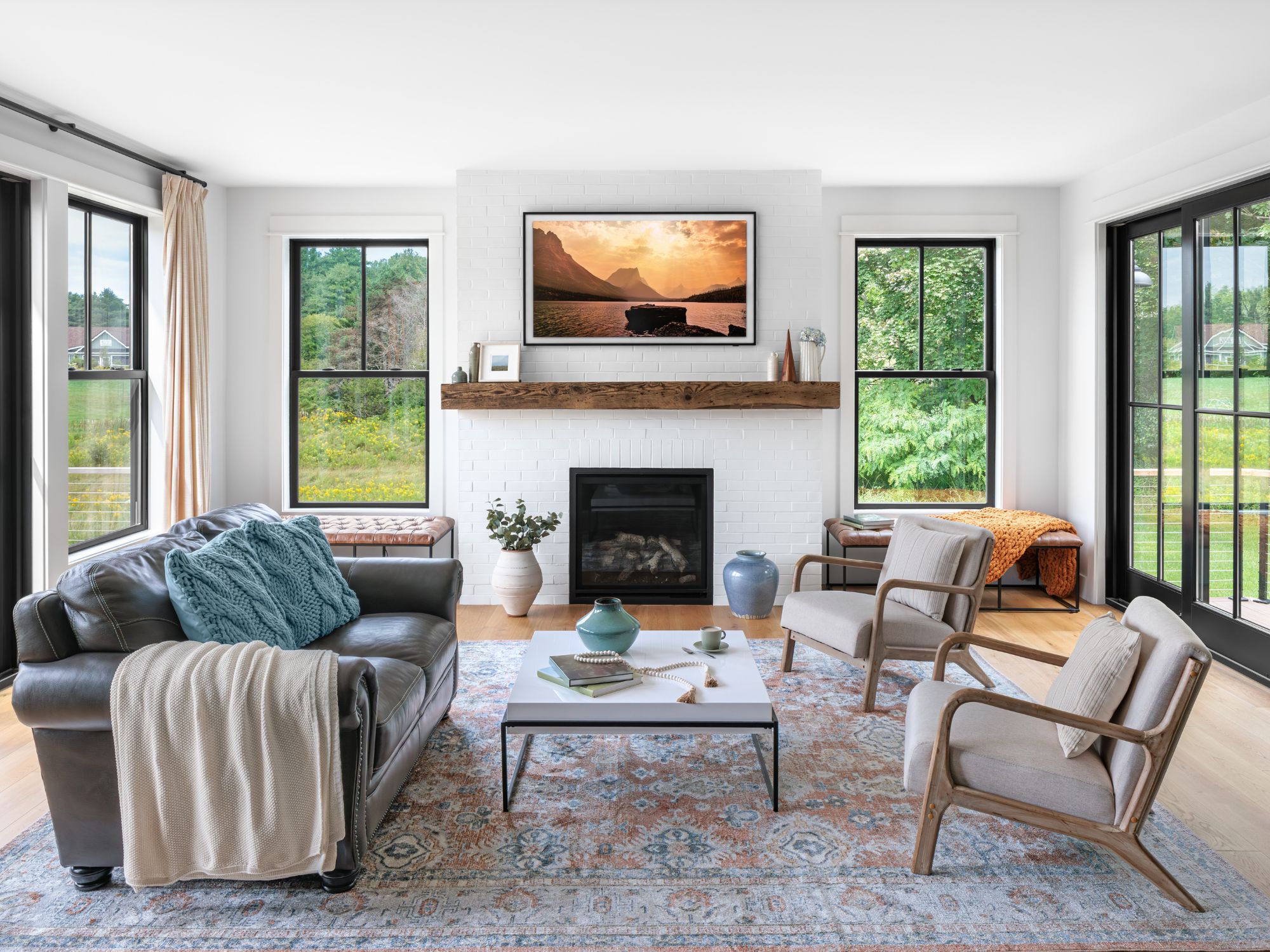 Renewal by Andersen windows in a living room with a wood floor and white walls. 