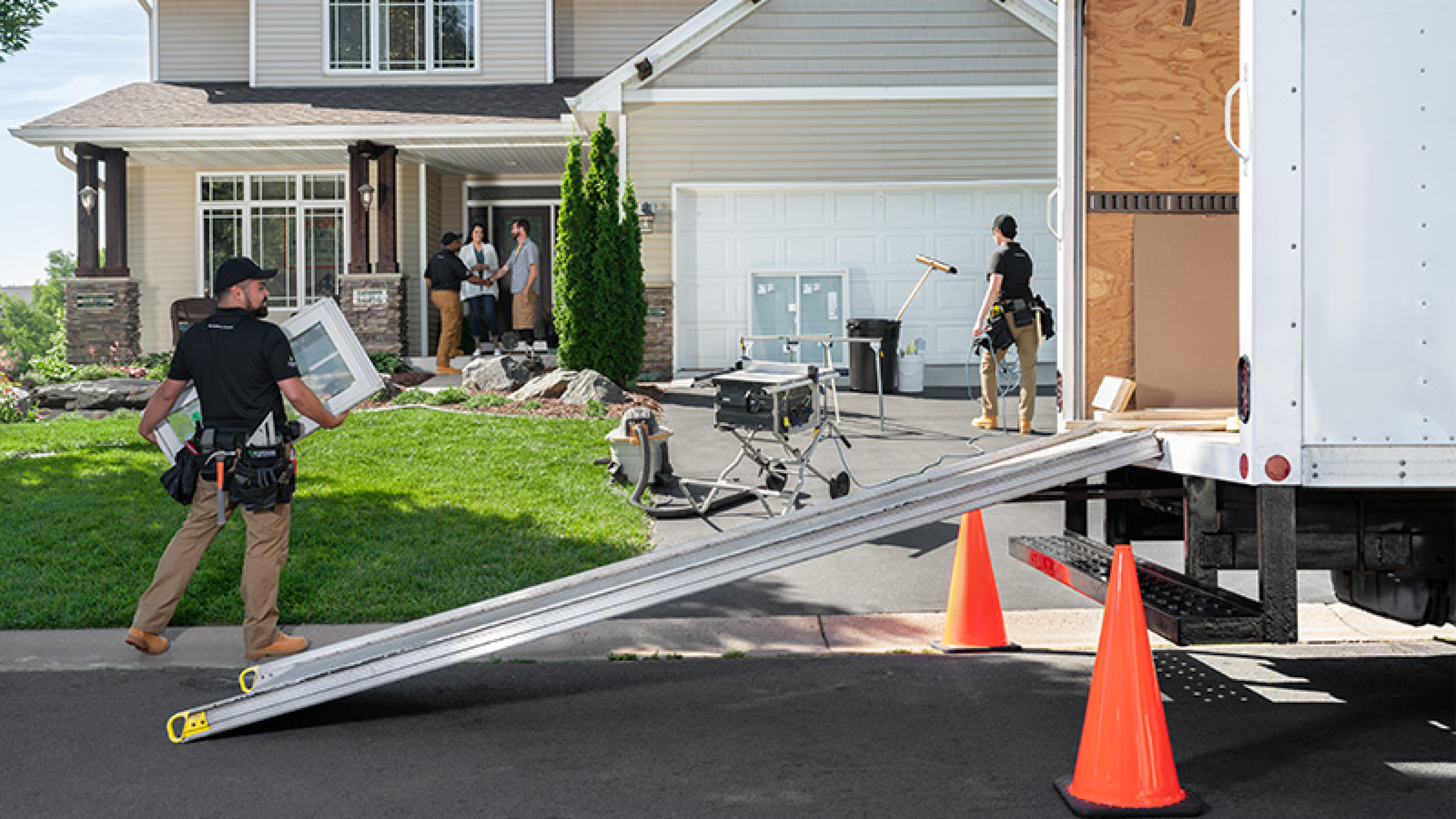 A team of professionals securing a freshly installed window by Renewal by Andersen