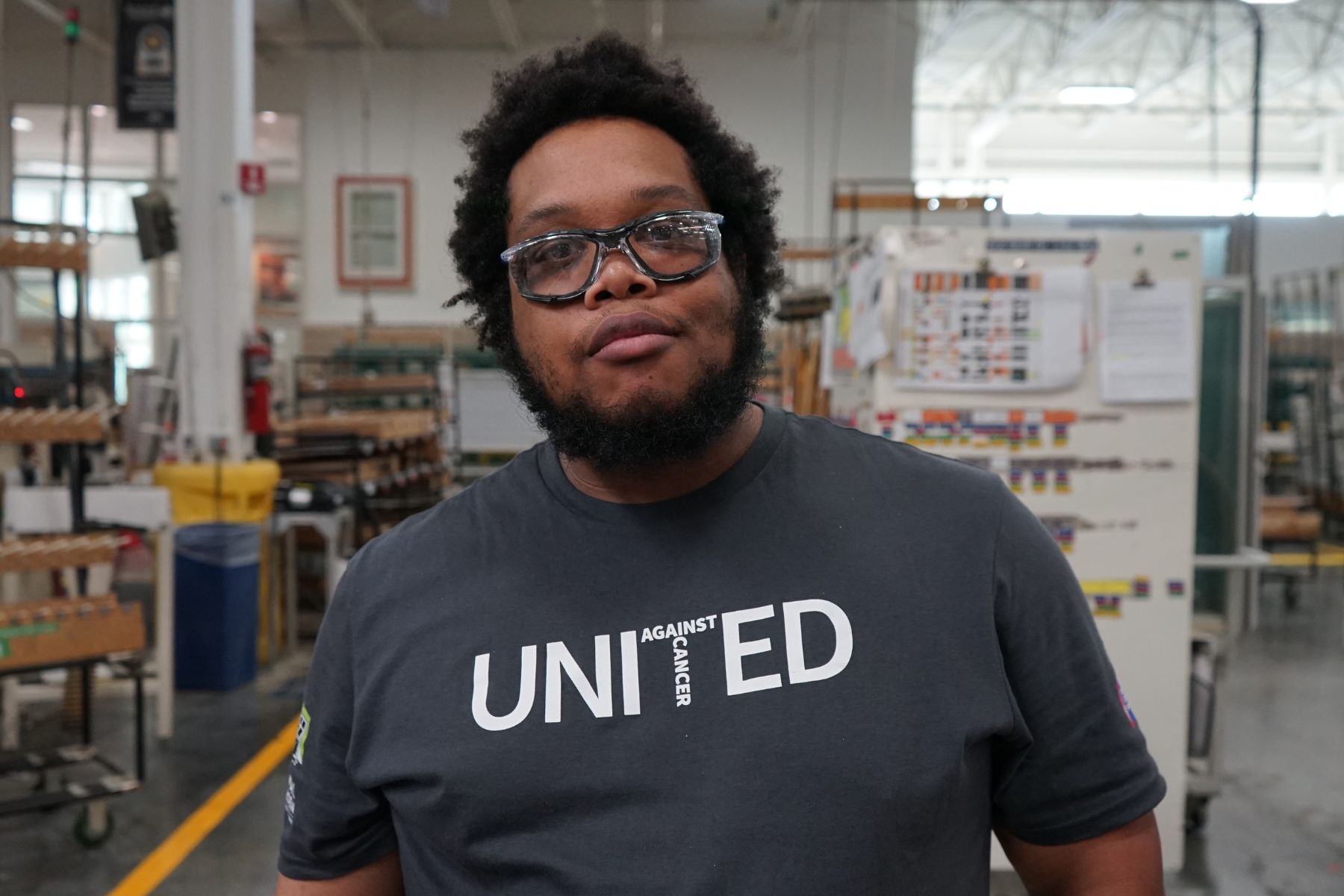 Portrait of RbA manufacturing employee wearing a United Against Cancer t-shirt.