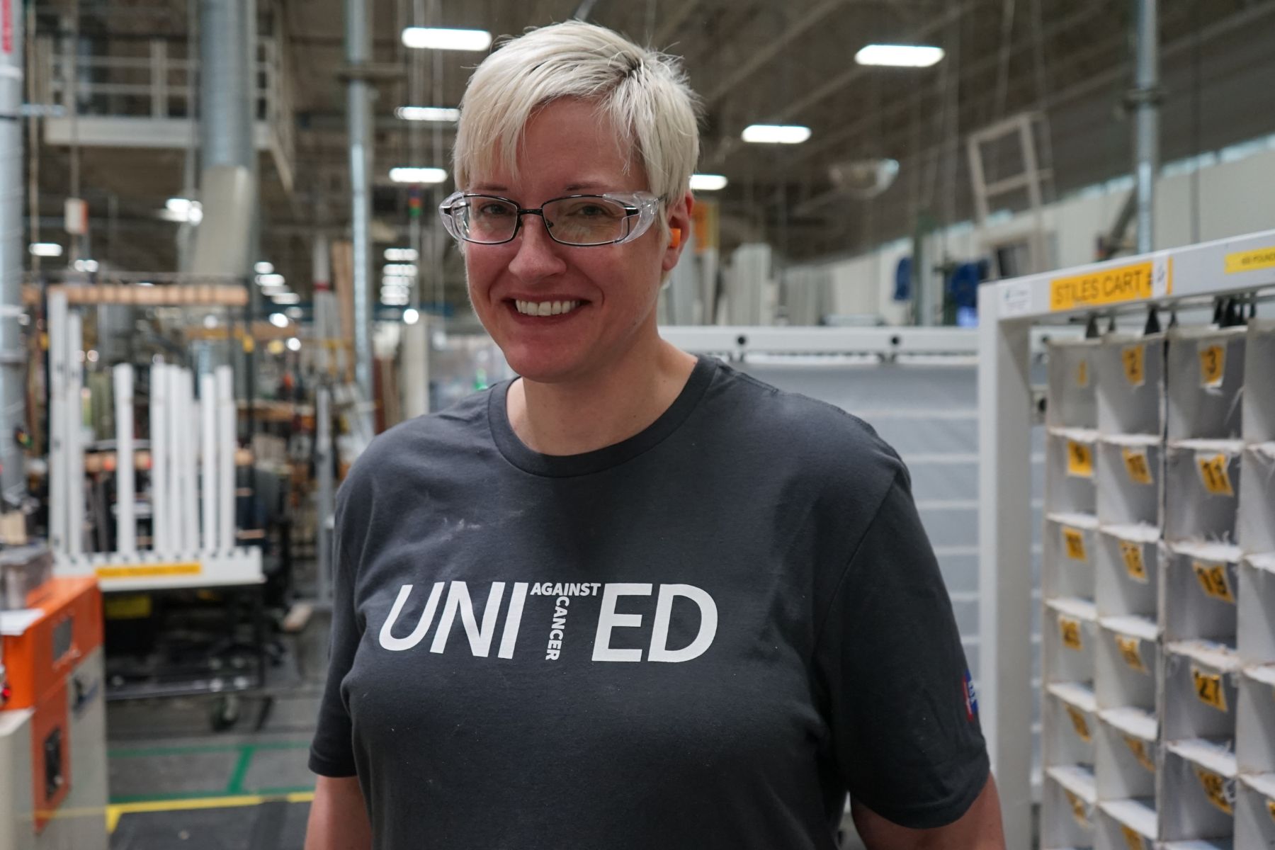 Portrait of RbA manufacturing employee wearing a United Against Cancer t-shirt.