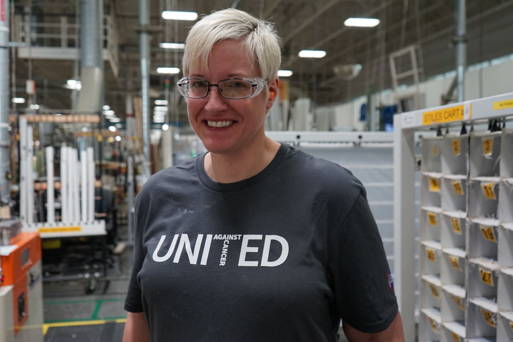 Portrait of RbA manufacturing employee wearing a United Against Cancer t-shirt.