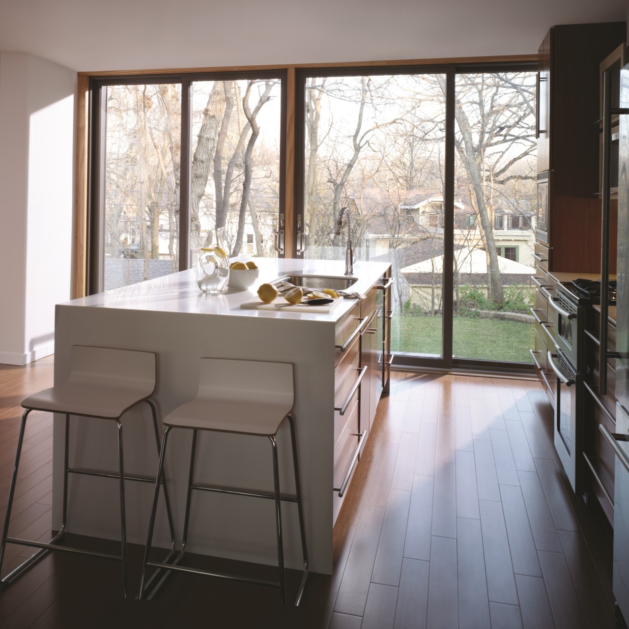 Sleek modern permashield sliding glass patio doors in kitchen with clean lines and wood accents.