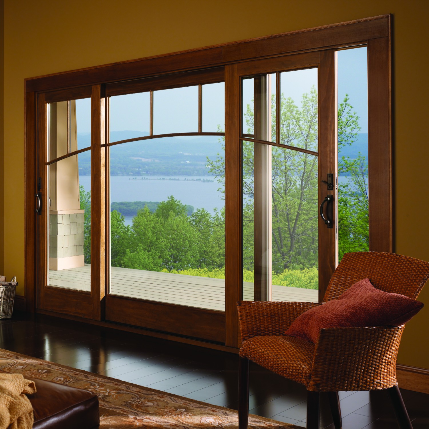 Two sliding a series traditional doors flanking a wide fixed door. They have custom grilles.