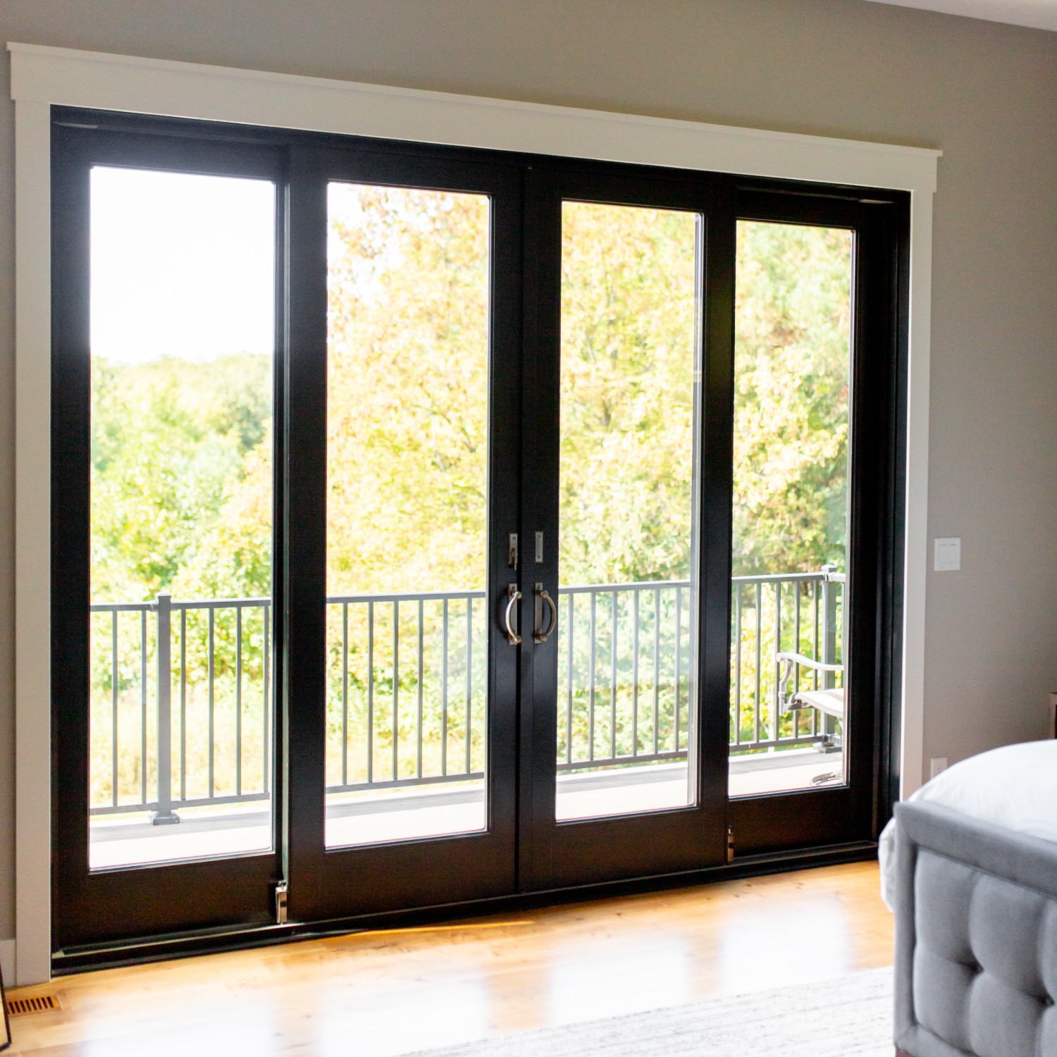 4 A-series doors. The center two doors are sliding doors. The doors are black.