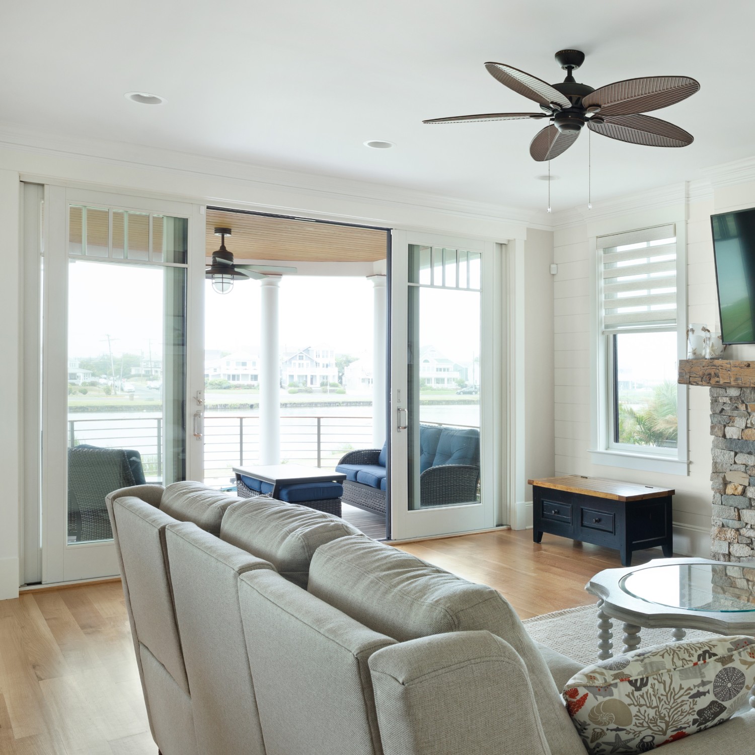 Sliding glass patio doors looking out over a coastal waterway