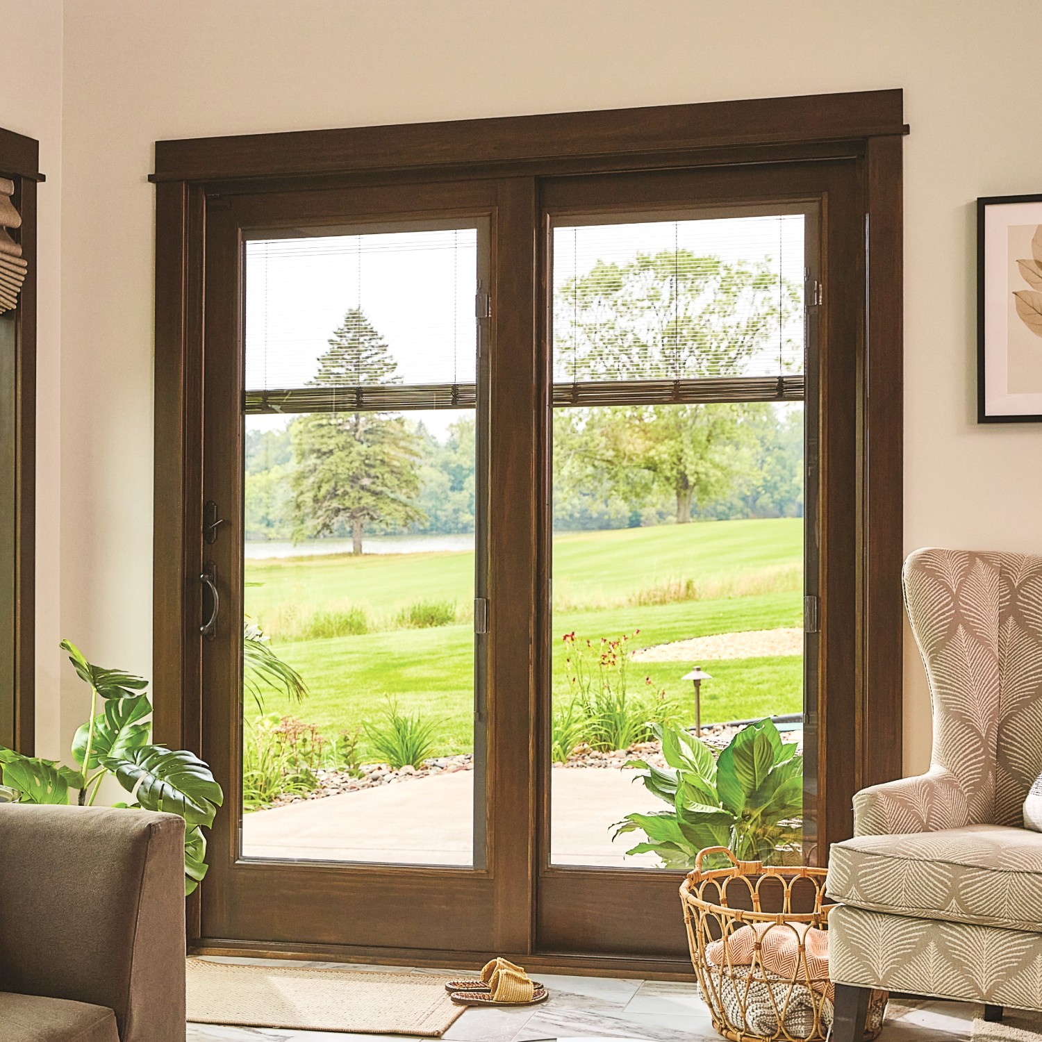 A-series traditional style sliding glass patio doors. These have a dark wood stain and blinds between the glass. There is a view of a gold course.
