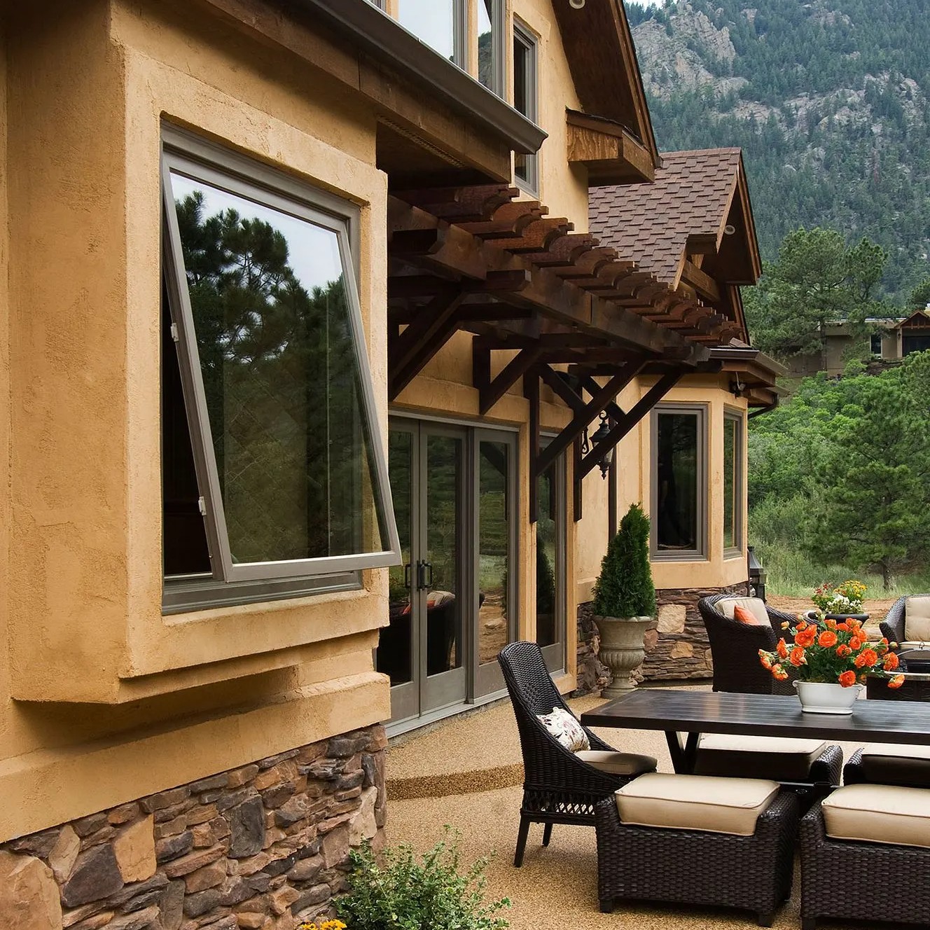 An exterior view of an awning window that is open and lets in fresh air in a mild rain.