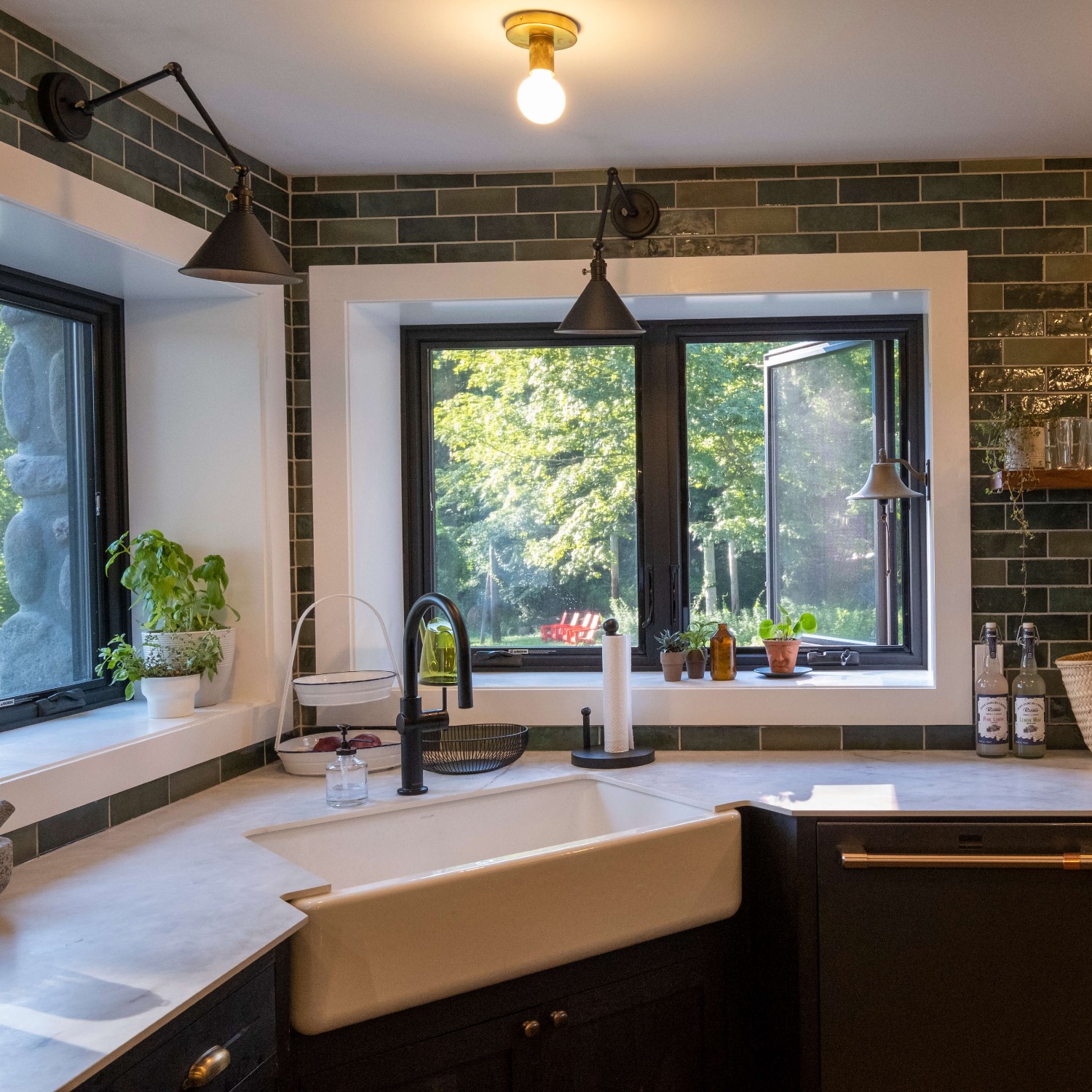 Black kitchen window in the casement style. Behind the sink in a corner. It is a mountain lodge.