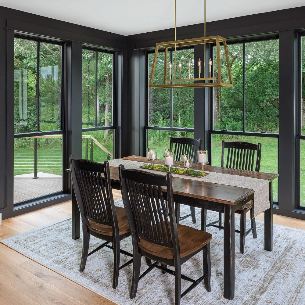 Floor to ceiling double hung windows in a dining room