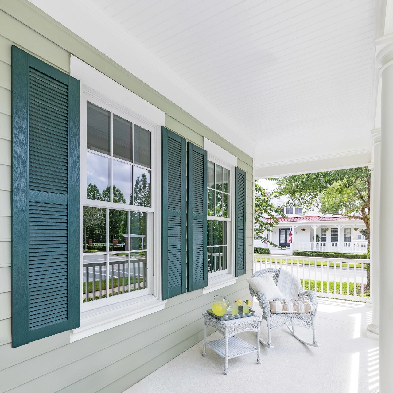 A southern coastal front porch with double hung windows and shutters