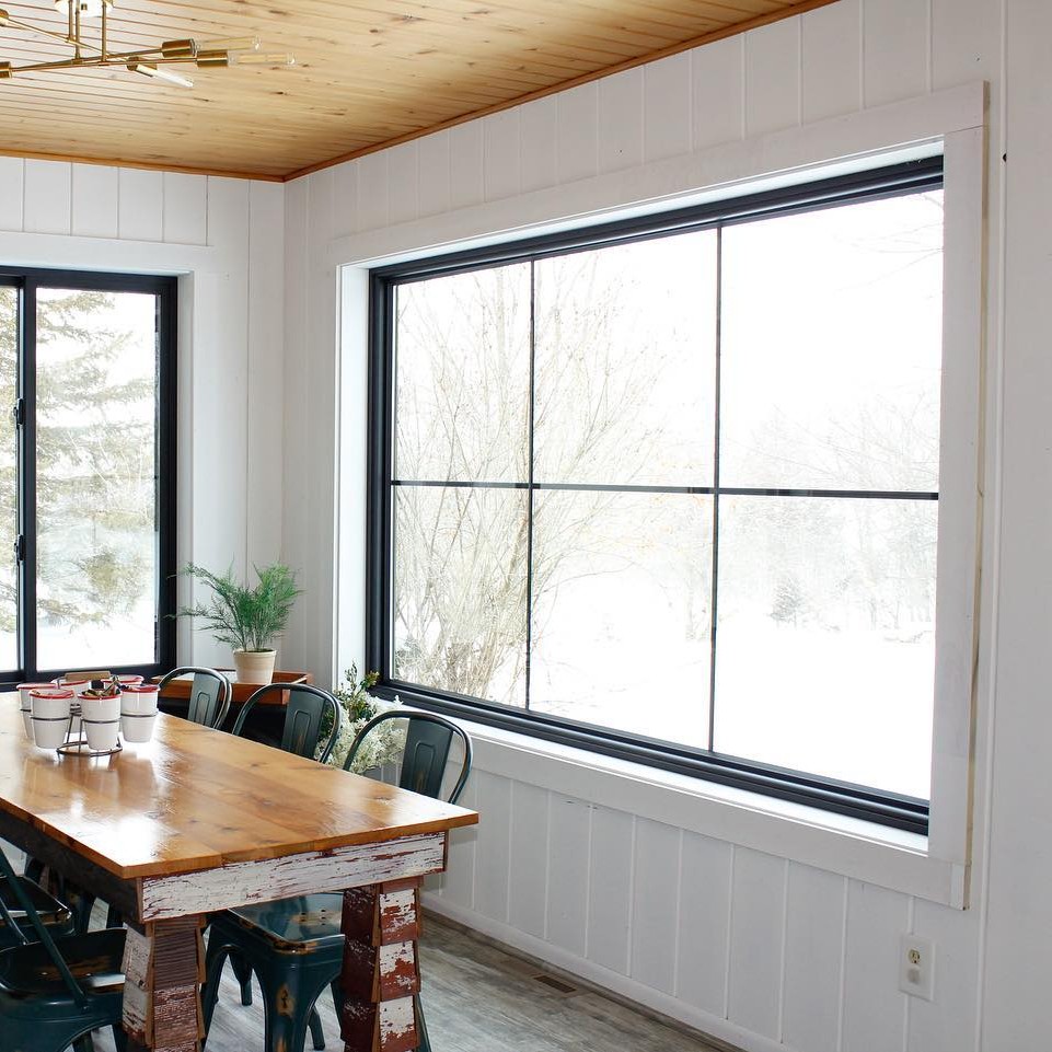 A large picture window that is rectangular and horizontal. It has equal lite grilles that are black.