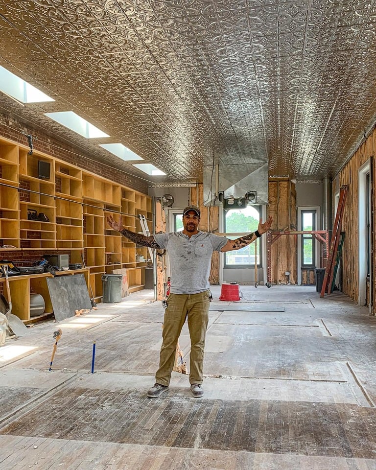 Anthony Carrino stands in his firehouse looking jubilant.