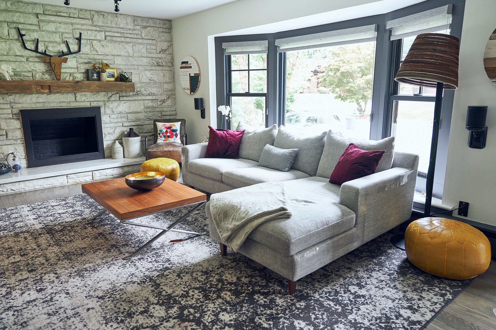 John's bay window inside his living room. He also has a large rug.