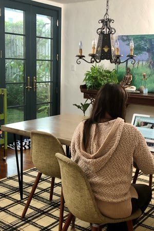 Laurie march works at her table. She has lovely new black doors and windows.