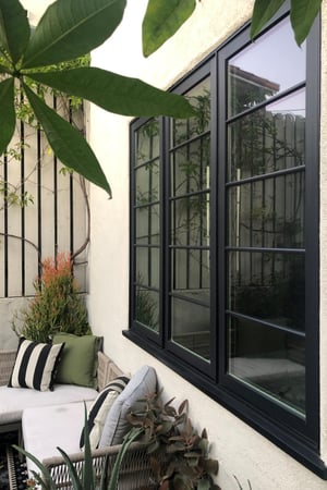 Casement windows overlooking the patio and courtyard.
